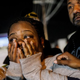 Latrice Radford reacts as she awaits news on her brother outside Gable House Bowl.
